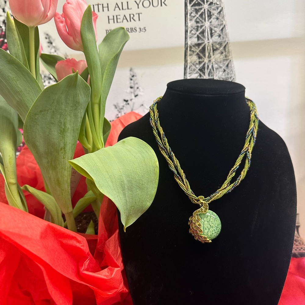 Gold tone necklace with peacock and green stone